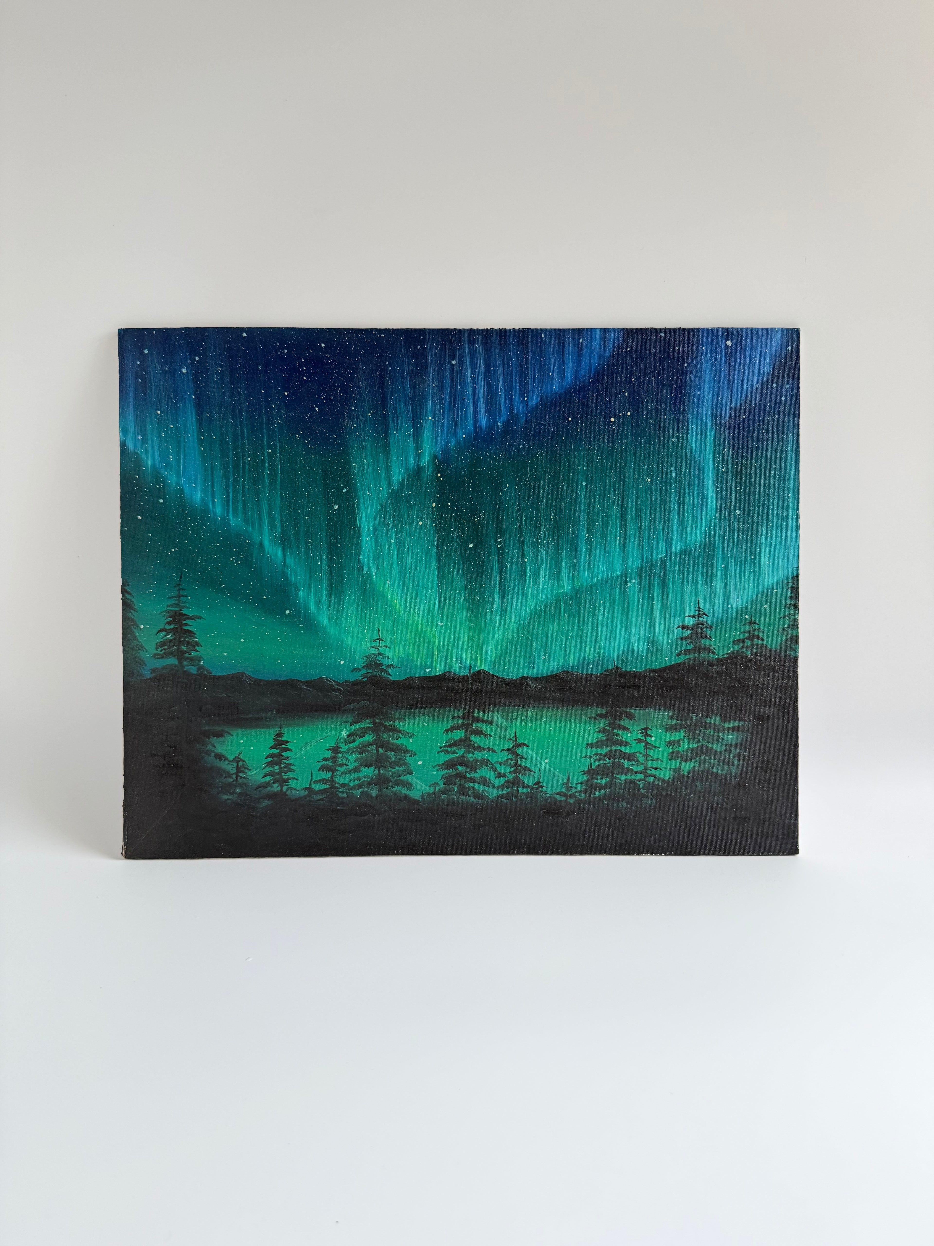 Original Aurora Borealis oil painting featuring vibrant Northern Lights reflected over a peaceful lake landscape.