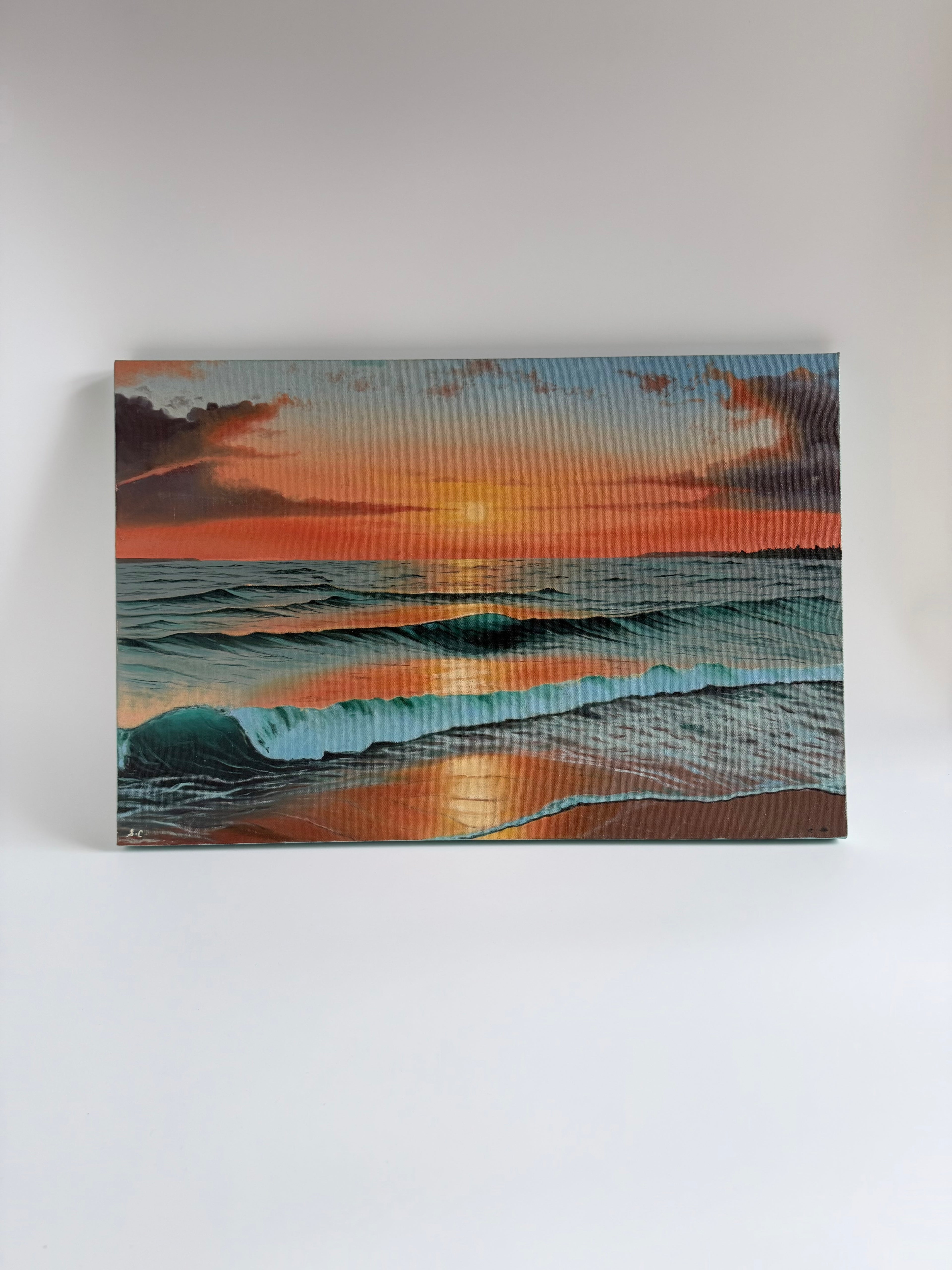 Original beach sunset oil painting featuring warm golden light reflecting across gentle ocean waves.